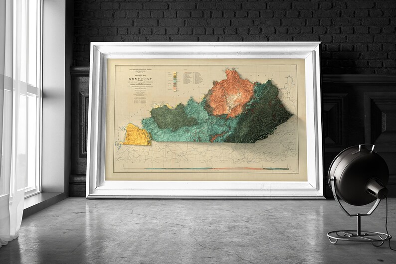May include: A vintage map of Kentucky in a white frame. The map is a relief map showing the different elevations of the state. The map is in shades of green, yellow, and orange.