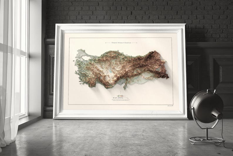 May include: A framed map of Turkey with a 3D topographic relief showing the country's mountains and valleys. The map is printed on a white background with a light brown border.