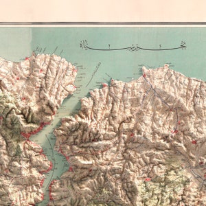 May include: A detailed map of a mountainous region with a large body of water in the center. The map is drawn in a vintage style with brown, blue, and red lines and text. The text is in Arabic.