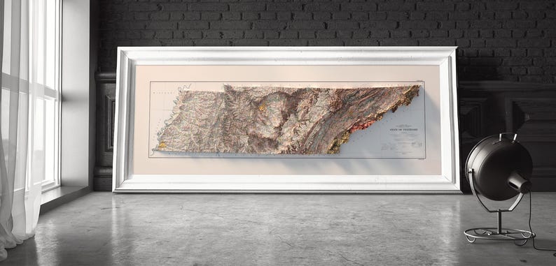 May include: A framed vintage map of the state of Tennessee with a raised relief design. The map is printed on cream-colored paper and shows the state's topography with brown, green, and red colors.