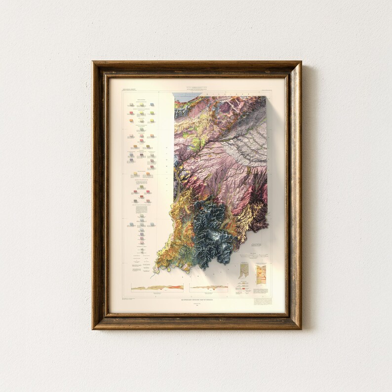 May include: A framed vintage map of Indiana, showing a detailed topographical view with a relief effect. The map uses a colour palette of greens, browns, and purples, set within a gold-toned wooden frame. The map includes various geographical details.