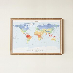 May include: A framed world climate map displaying the K&ouml;ppen-Geiger climate classification system. The map features a light blue ocean background with landmasses color-coded in shades of red, orange, yellow, green, and blue to represent zones.