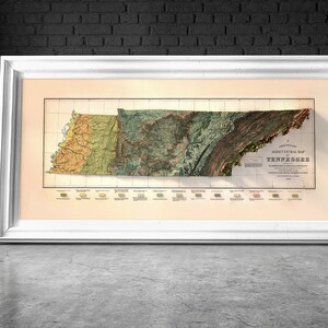 May include: A vintage, framed map of Tennessee with a relief-style design. The map is printed in shades of green, brown, and yellow, and shows the state's topography. The title "Geological Map of Tennessee" is printed in the lower right corner.