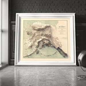 White wooden framed Alaska map art as a romantic gift. The print features the Arctic National Wildlife Refuge and Northern Lights hues, symbolizing enduring adventure—perfect for anniversaries, elopement mementos, or celebrating a life-changing Alaskan journey together.