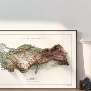May include: A framed map of Turkey with a 3D topographic relief showing the country's terrain. The map is titled "T&uuml;rkiye Y&uuml;kseklik Haritası" in Turkish, which translates to "Turkey Elevation Map".