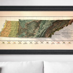 May include: A vintage, framed, relief map of Tennessee. The map is in shades of green, brown, and yellow, and shows the state's geological features. The title "A Preliminary Geological Map of Tennessee" is printed in the lower right corner.