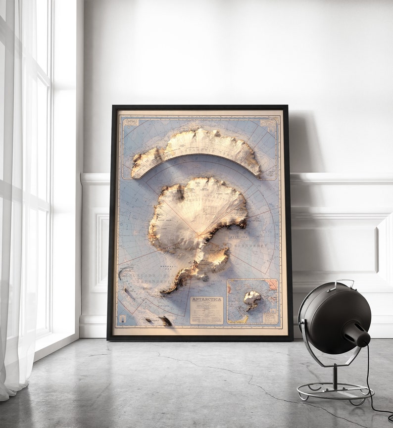 May include: A vintage-style map of Antarctica in a black frame. The map is printed on a light blue background with brown and white details. The map shows the continent's coastline, major features, and surrounding islands. The word "ANTARCTICA" is printed in the lower right corner of the map.