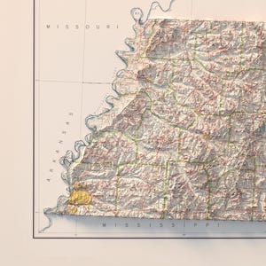 May include: A vintage-style topographic map of the state of Arkansas. The map shows the state's borders, major cities, and rivers. The map is printed in shades of brown, green, and blue.