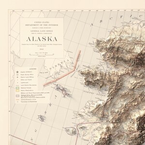 May include: A vintage topographic map of Alaska, featuring detailed relief shading and geographical features. The map includes the text "ALASKA" and "UNITED STATES DEPARTMENT OF THE INTERIOR". The map is printed on aged paper with a legend and various labels.