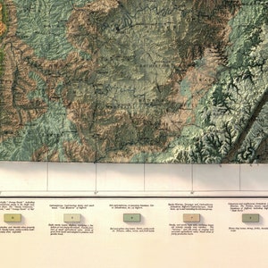 May include: A vintage map of North Carolina, showing the state's counties and soil types. The map is divided into sections, each with a different color representing a different soil type. The map also includes a key that explains the different soil types.