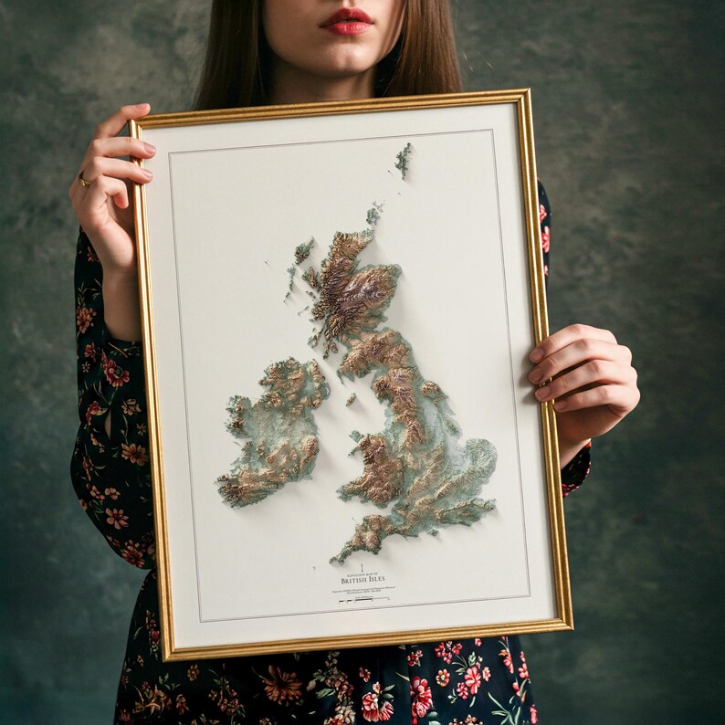 May include: Framed 3D relief map of the British Isles, featuring detailed topographical features in shades of brown and green. The map is set against a white background and framed in a gold-colored frame.