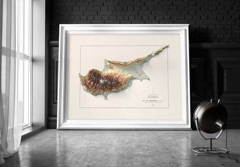May include: A framed 3D topographic map of Cyprus, showing the island's terrain in shades of green, brown, and beige. The map is titled "Cyprus" and is surrounded by a white frame.