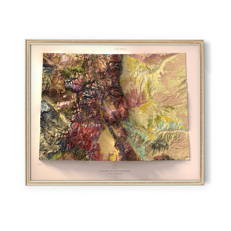 May include: A framed geologic map of Colorado, featuring a detailed relief with various colors representing different geological formations. The map is encased in a gold-colored frame, with the title "GEOLOGIC MAP OF COLORADO" printed at the bottom.