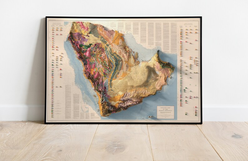 May include: A vintage-style topographic map of the Arabian Peninsula, showing the geological formations and elevation changes in a 3D effect. The map is printed in muted colours and includes a key with different coloured symbols representing various geological features.