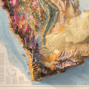 May include: A detailed geological map of a region, featuring a range of colours and textures representing different rock formations. The map depicts a coastline with a body of water and a mountainous area.