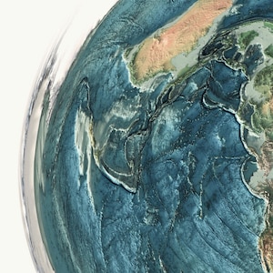 May include: A detailed, three-dimensional rendering of a portion of Earth, showcasing the ocean floor and landmasses. The image features shades of blue and green, with intricate textures representing underwater topography and continental formations.