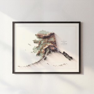May include: Framed 3D elevation map of Alaska, featuring detailed topographical relief in shades of brown, green, and white. The map is set against a white background, enclosed in a black frame, and includes the text "Elevation Map Alaska".