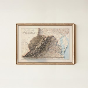 May include: Framed vintage map of Virginia, featuring detailed topographical information and the title "Map of the State of Virginia." The map is in a gold-colored frame, showcasing a detailed depiction of the state's landscape.