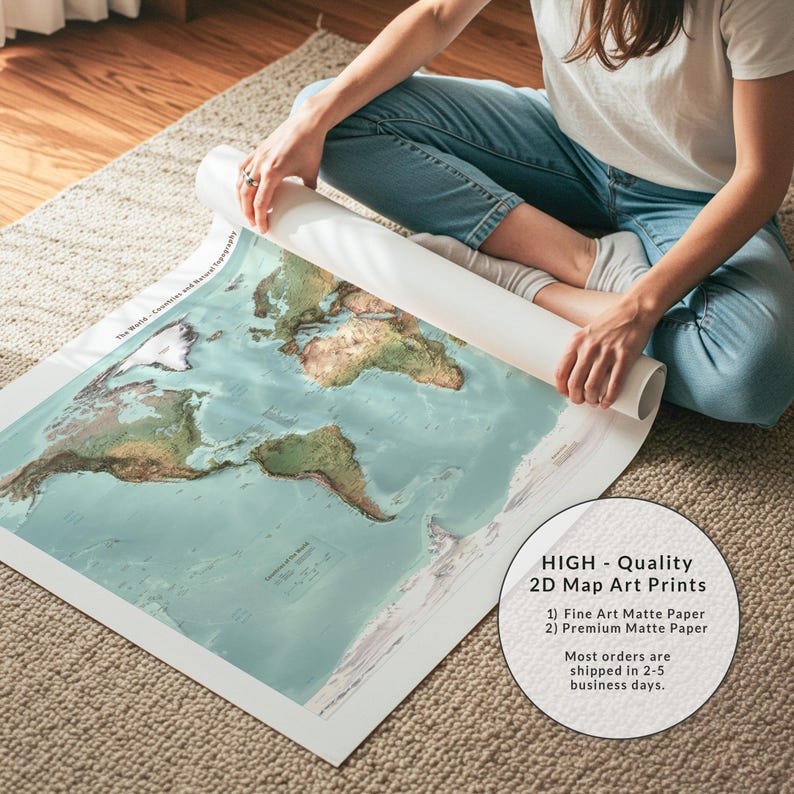 May include: A large, rolled-up world map print on matte paper featuring detailed topography with green landmasses and light blue oceans. The map displays the text The World - Countries and Natural Topography and includes a legend in the corner.