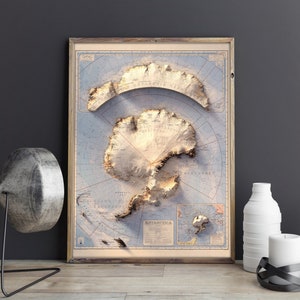May include: A vintage-style map of Antarctica in a wooden frame. The map is printed on a light blue background with brown lines and text. The continent of Antarctica is shown in a light brown colour with a 3D effect.