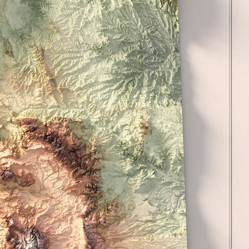 May include: A close-up of a topographic map showing a mountainous region with shades of green, brown, and beige.