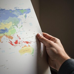 May include: A world map printed on white paper featuring colorful regions representing different countries and territories. The map displays labels for major landmasses including China, Mongolia, and Australia, alongside bodies of water like the Indian Ocean.