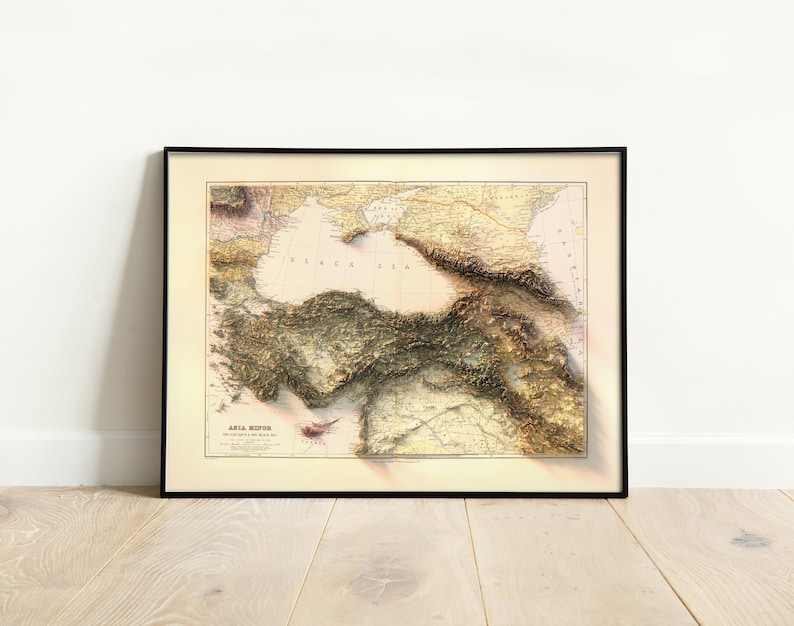 May include: A vintage map of Asia Minor, showing the topography of the region with detailed shading and lines. The map is framed in black and has the title "Asia Minor" at the bottom.