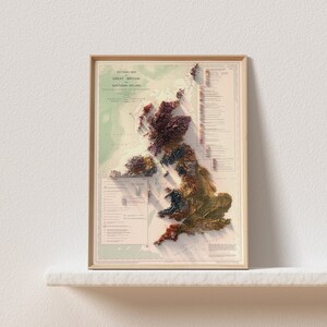May include: A vintage-style tectonic map of Great Britain and Northern Ireland. The map is printed on paper and features a 3D relief effect. The map is framed in a light wood frame.