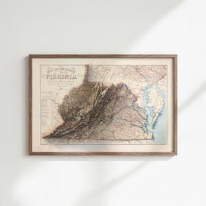 May include: A framed vintage map of Virginia, featuring detailed topographical information. The map is in a wooden frame and displays the state's geographical features, including mountains and waterways. The title "Map of the State of Virginia" is visible.