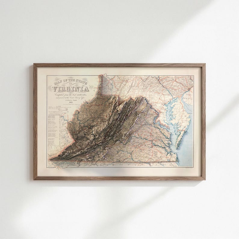 May include: A framed vintage map of Virginia, featuring detailed topographical information. The map is in a wooden frame and displays the state's geographical features, including mountains and waterways. The title "Map of the State of Virginia" is visible.
