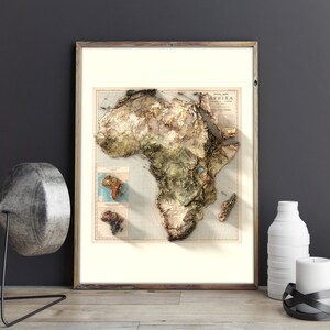May include: A framed vintage map of Africa with a 3D embossed effect. The map is printed on cream paper with brown and green colors. The title of the map is "AFRIKA" in a vintage font.