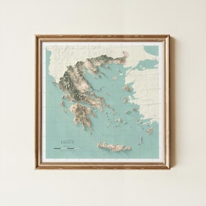 May include: A framed topographic map of Greece featuring a light teal ocean background and cream-colored landmasses with detailed 3D-style relief shading. The map includes a grid overlay, a scale bar, and the text "TOPOGRAPHY OF GREECE".