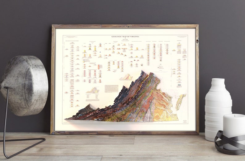 May include: A vintage-style geological map of Virginia, framed in a light wood frame. The map shows the state's geological formations in a colorful, detailed illustration.