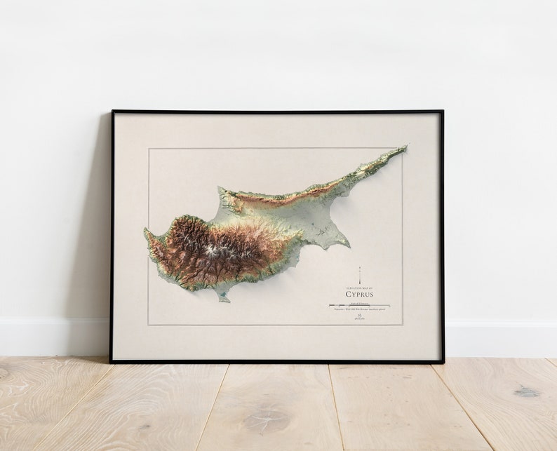 May include: A framed topographic map of Cyprus, showing the island's terrain in shades of green, brown, and beige. The map is titled "Cyprus" and includes a scale bar and compass rose.