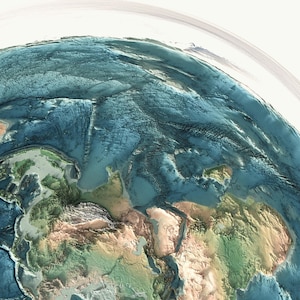 May include: A 3D rendered image of Earth, showcasing the continents and oceans. The image highlights the topography with varying shades of green, brown, and blue. The curvature of the planet is visible, with a bright white background.