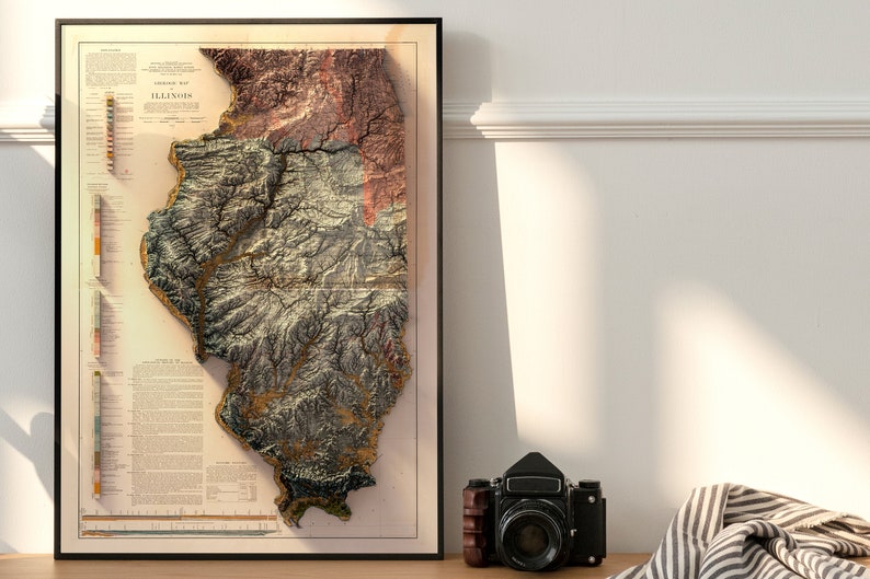May include: A framed topographic map of the state of Illinois, with a vintage style and a 3D effect. The map is printed on a cream-colored background with brown, green, and gold accents.