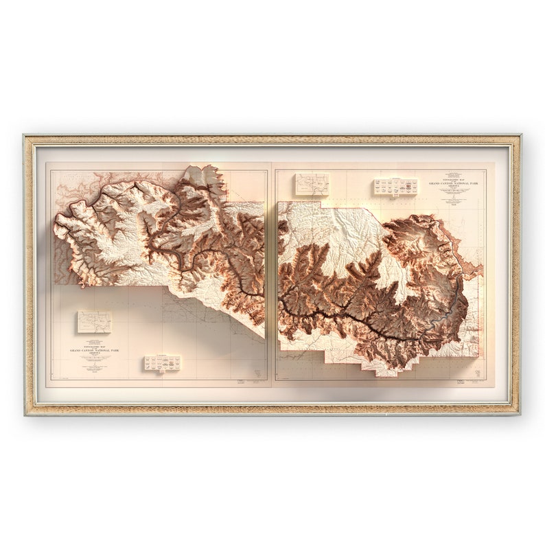 May include: Framed relief map of Grand Canyon National Park, showcasing the canyon's topography in shades of brown and beige. The map is encased in a light-colored wooden frame, offering a detailed 3D representation of the landscape.