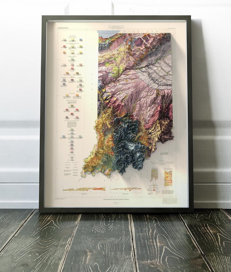 Op de afbeelding: Een vintage, kleurrijke 3D-reli&euml;fkaart van Indiana, die de geologische formaties van de staat laat zien. De kaart is zwart ingelijst en bevat een sleutel voor de verschillende geologische formaties.