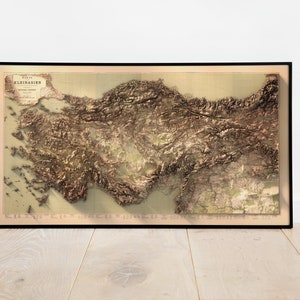May include: A vintage map of Asia Minor, also known as Anatolia, with a relief-style depiction of the terrain. The map is framed in black and has a title in the top left corner that reads "Karte Kleinasien" in German.