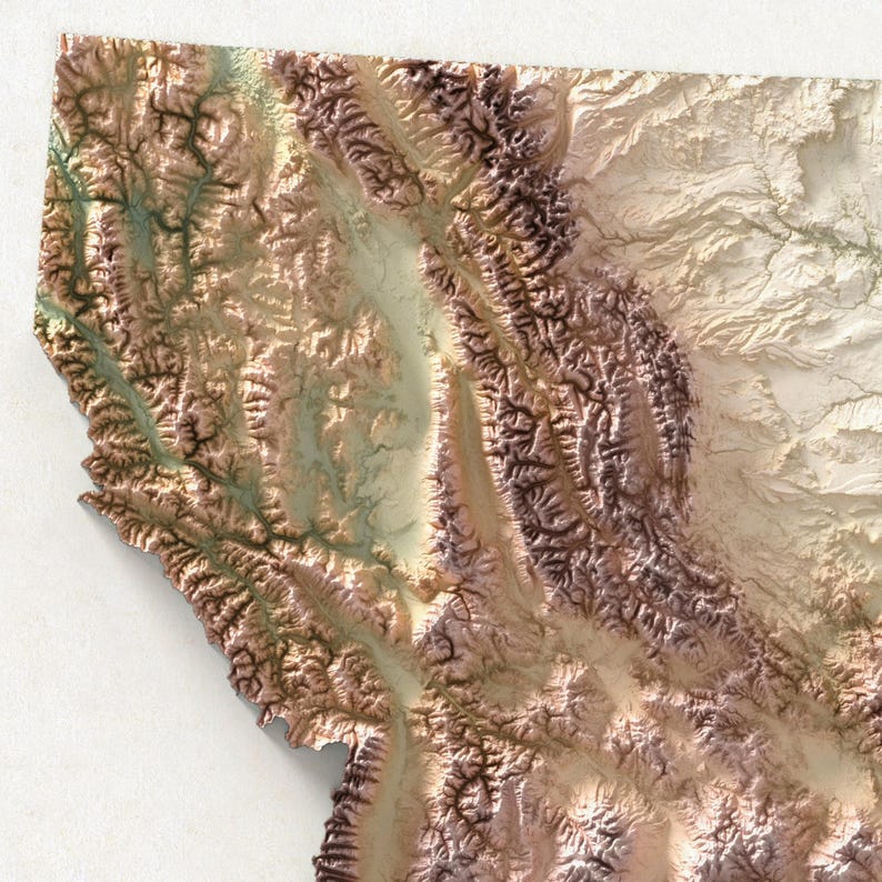 May include: A detailed relief map of Montana, USA, showcasing the state's mountainous terrain. The map features a 3D effect with varying shades of brown, tan, and green, highlighting the valleys and peaks. The map is a close-up view, with the state's outline visible.
