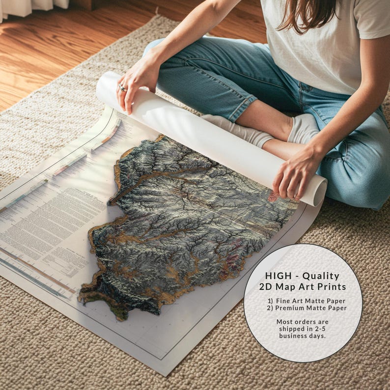 May include: A detailed 2D map art print with a textured, topographic design. The map is primarily gray and brown, with a white border. The print is being unrolled, revealing the intricate details of the artwork. The image includes text that says "HIGH - Quality 2D Map Art Prints".