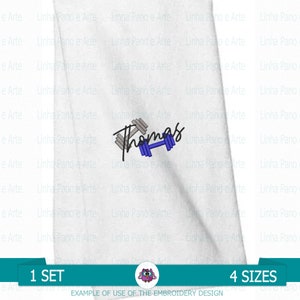 May include: White fabric with the name "Thomas" embroidered in blue cursive script with a gray dumbbell graphic.