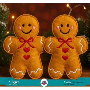 May include: Two felt gingerbread man ornaments with smiling faces, red bow ties, and heart accents. The gingerbread men have white icing details and are set against a blurred background with Christmas lights and greenery. Text reads "1 SET".