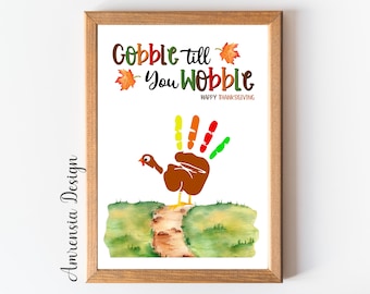 May include: A printable Thanksgiving craft for kids. The image shows a handprint turkey with colorful feathers and the text "Gobble till you wobble Happy Thanksgiving".