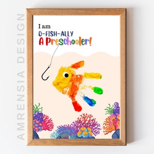 May include: A printable art print with a handprint fish design. The fish is orange, yellow, red, green, and blue. The text reads "I am D-FISH-ALLY A Preschooler!"