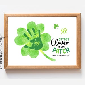 May include: A green four-leaf clover with a handprint in the center. The text "Cutest Clover in the Patch" is written below the clover. The text "Happy St. Patrick's Day" is written below the phrase.
