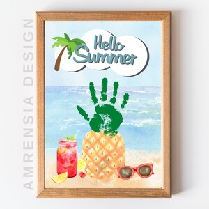 May include: A framed watercolor painting of a pineapple with a green handprint on top. The pineapple is on a beach with a blue ocean and a palm tree in the background. The text "Hello Summer" is written in a white cloud above the pineapple.