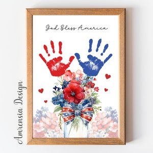 May include: A framed print with a red and blue handprint design, a bouquet of red, white, and blue flowers in a mason jar, and the text "God Bless America".