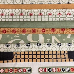 May include: A collection of fabric strips with different patterns and colours, including green, brown, white, and red. The strips feature various designs, such as floral patterns, geometric shapes, and numbers. The fabric strips are arranged in a vertical stack, with the top strip being a solid brown colour and the bottom strip featuring a white background with red letters spelling out the alphabet.