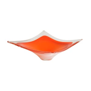 May include: A square-shaped glass bowl with a clear rim and an orange center. The bowl has a white base.